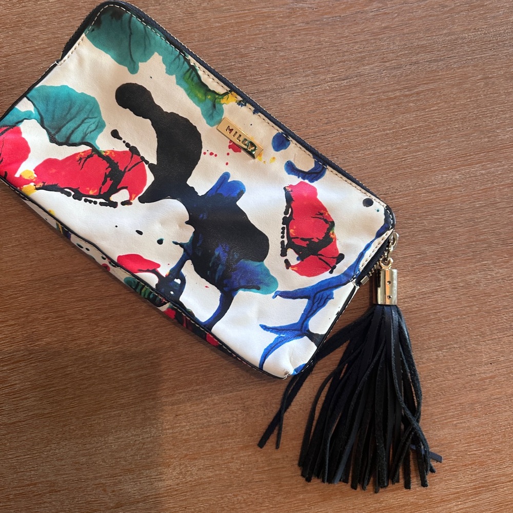 Milly leather paint splatter clutch with black tassel